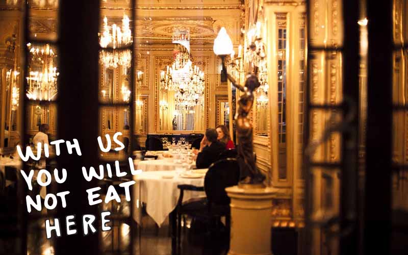 Picture of fancy restaurant with writing that states "With us you will not eat here"