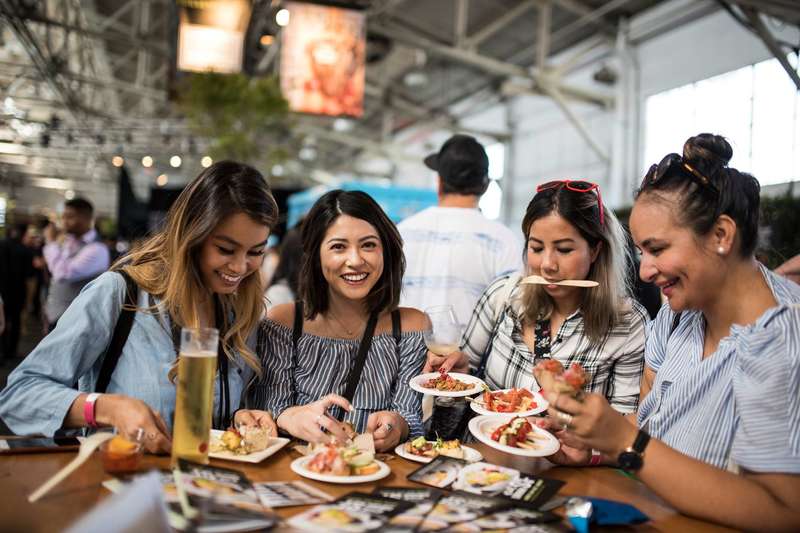 Four female friends sitting together at a table enjoying small plates and drinks. San Francisco Food Tours