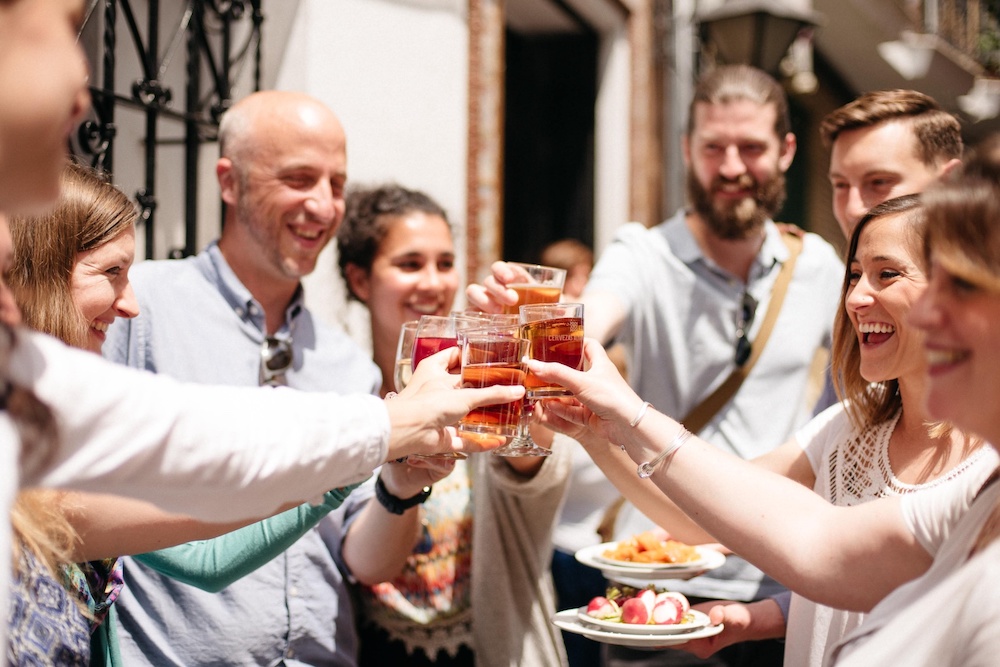 Lisbon food tours group hold up glasses to cheer