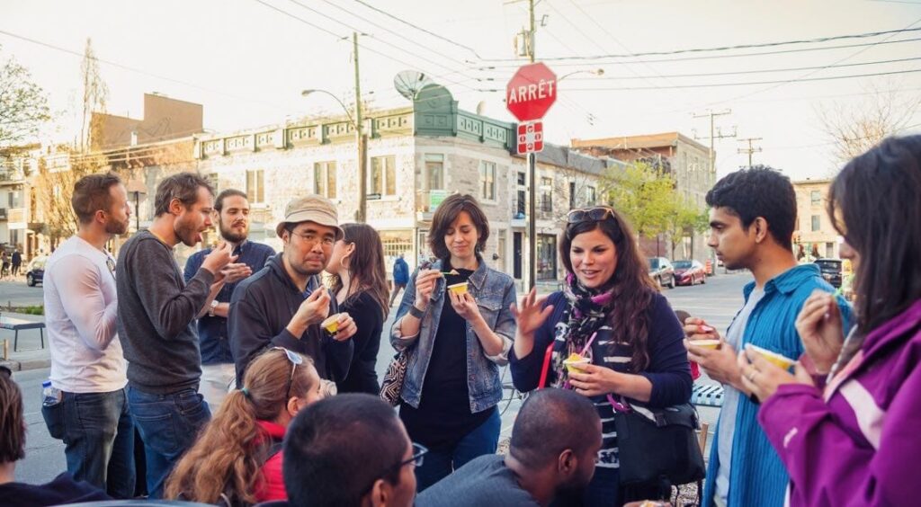 People gathered and eating ice cream on a food tour in montreal