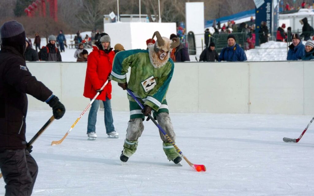A mascot playing hockey at La fete des neiges