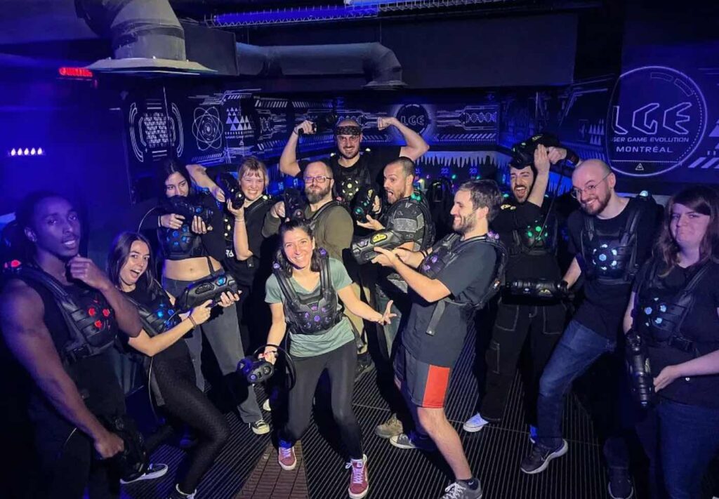 A group of people playing laser games together