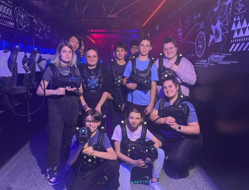 A group of kids playing laser games together