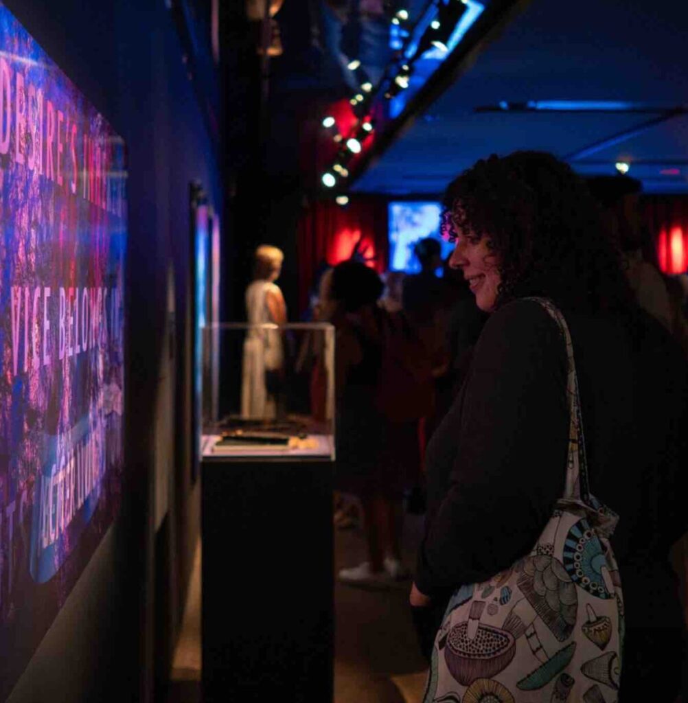 A women watching the Mère Mémoire Cellophane exhibit at the McCord Museum
