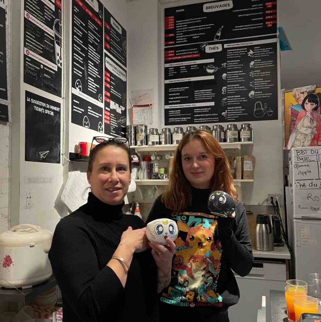 A mom and daughter holding a mug