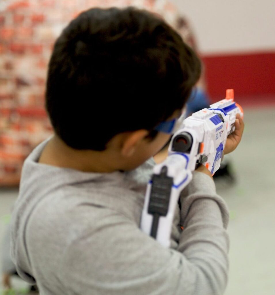 A kid aiming his nerf gun