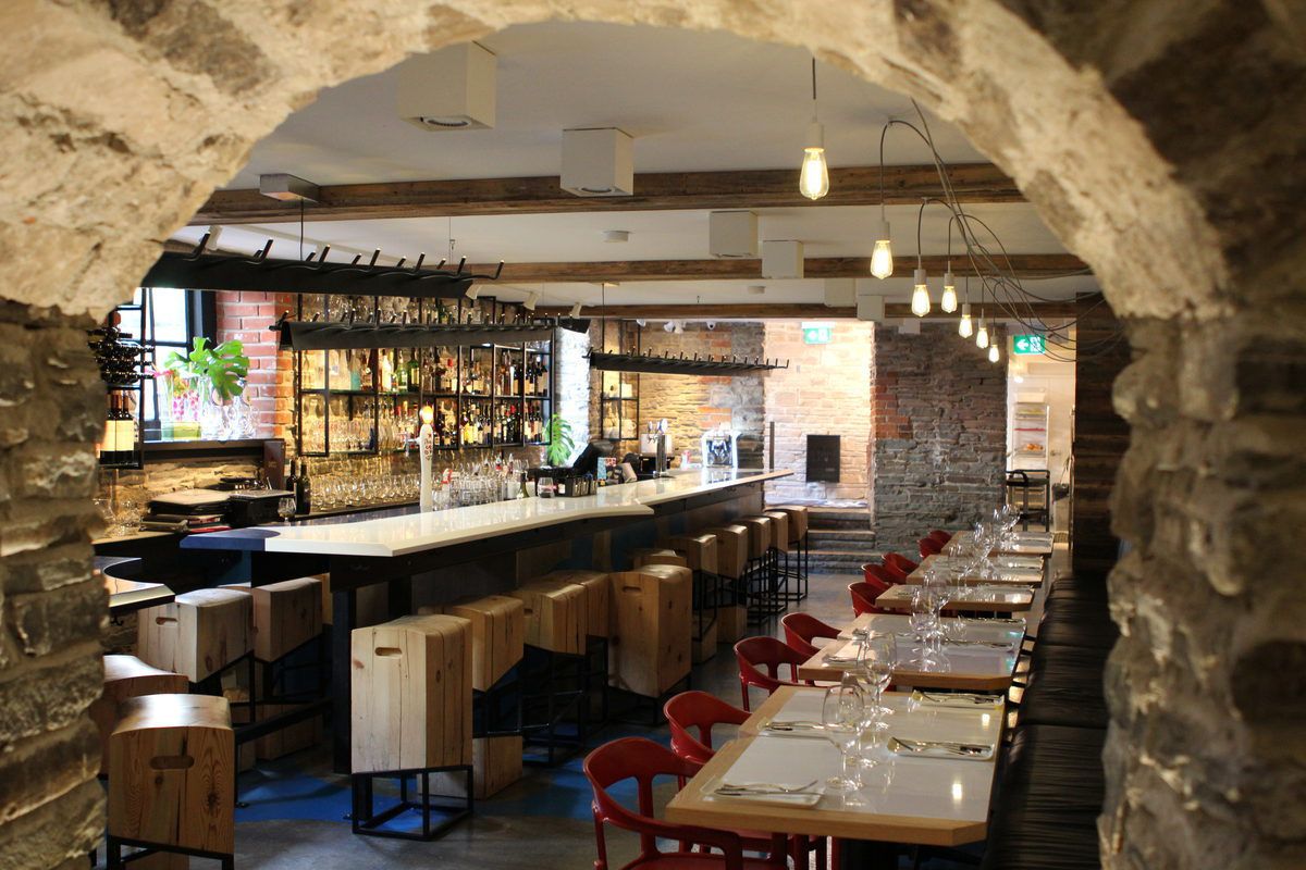 Industrial-chic dining space with full service bar and exposed brick walls.