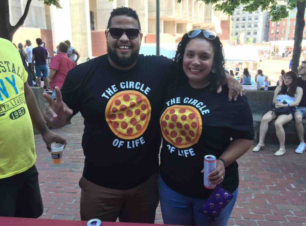 A couple smiling with a shirt that says the circle of life