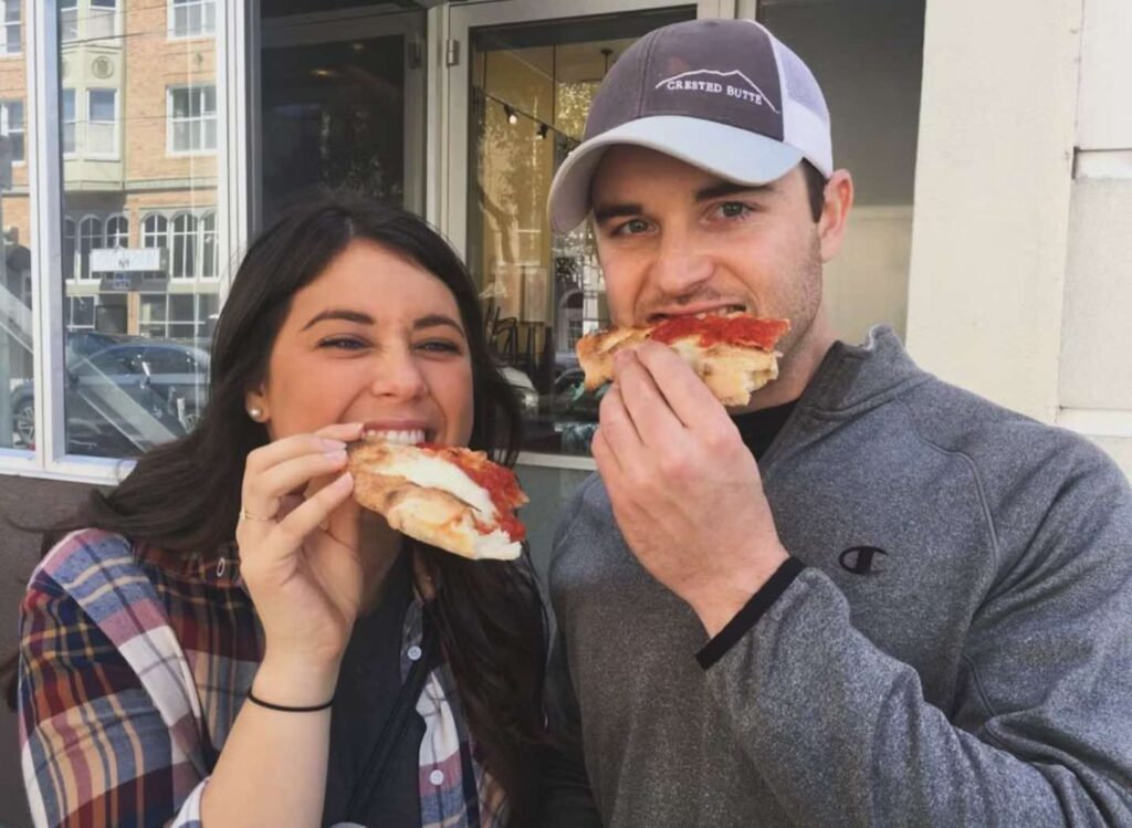 A couple enjoy Pizza with Sidewalk Food Tours
